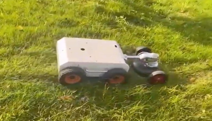 Robot mower on lawn angled view