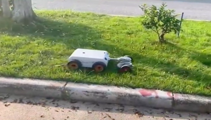 Robot mower working along curb and tree