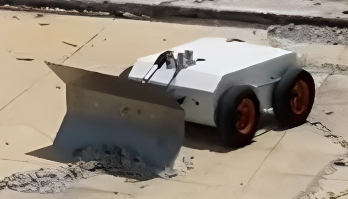 Robot with large plow blade pushing sand